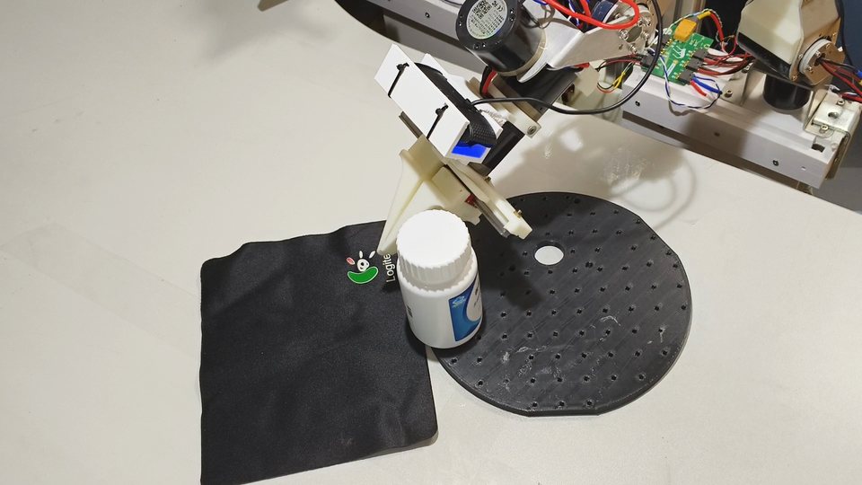 DIYRobot pulling a pill bottle across the work surface